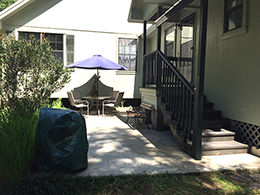 Private entrance and patio with charcoal grill.